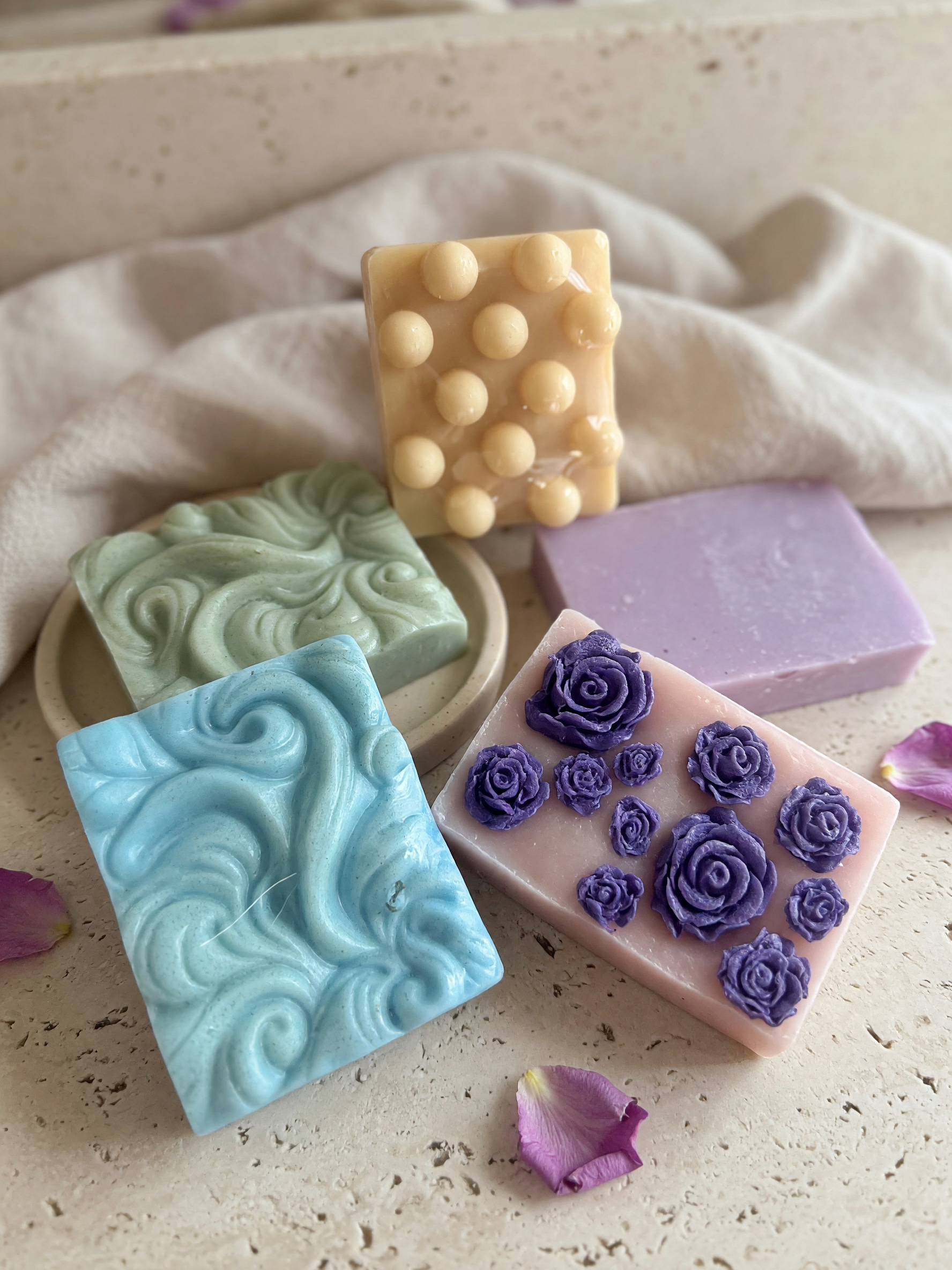 Pastel decorative soap bars with swirls, massage bumps, and purple roses